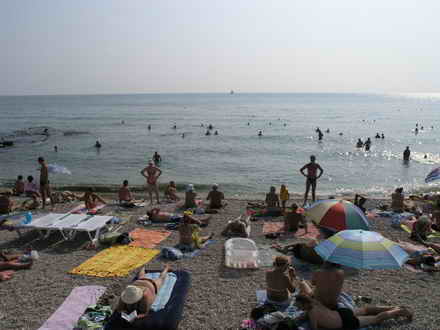 Holidaymakers sunbathe