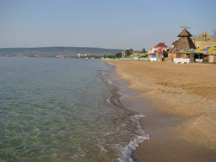 Sparkling sea and golden sand against the backdrop of the mountains
