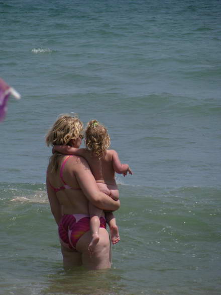 Rosy-cheeked toddler swimming