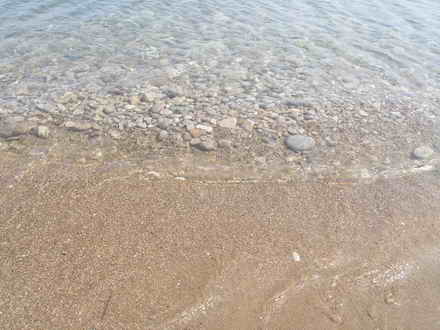 On the bank of sand in a sea of stones